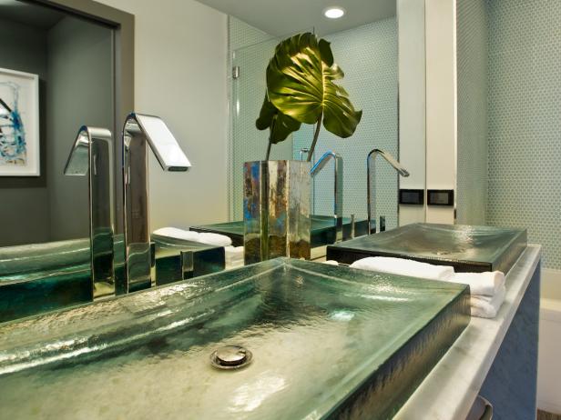 Lending a natural element and the needed pop of color, a mercury-glass vase, inspired by the design of a nighttime city skyline, holds a solitary split-leaf philodendron. Guest Bathroom of the HGTV Urban Oasis 2012 located in Miami, FL.