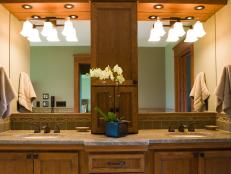 This master bathroom has a custom-designed his-and-hers vanity with a granite countertop.