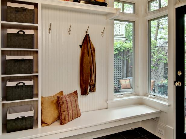 "Mudrooms are typically small in square footage, so make the most of the space by going vertical," JoLynn Johnson says. "Add shelves where bins and baskets can be placed for easy access. Smaller items like hats, gloves and scarves can be stored in the bins." This traditional mudroom offers all the storage amenities of a spacious room compacted into one unit. Storage shelves, baskets, hooks, bench seating and convenient floor storage all help keep mudroom contents tidy and within reach.