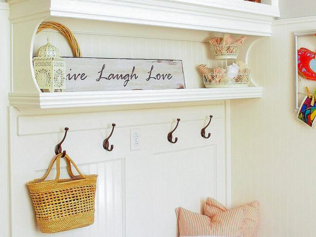 Don't be afraid to integrate your home's style and personality into your mudroom design. Design blogger Kristin Salazar designs her mudroom as a direct reflection of her home's shabby chic charm, while still using it as a functional entry storage spot. Rather than wasting wall space, Kristin adds a small shelf to house charming decorative accents.
