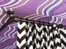 In order for bed drapery to hang properly, itâ  s best to install it on ceiling-mounted hardware. These black and white zig zag drapery panels coordinate perfectly with a wraparound track and drapery rings in a satin black finish.