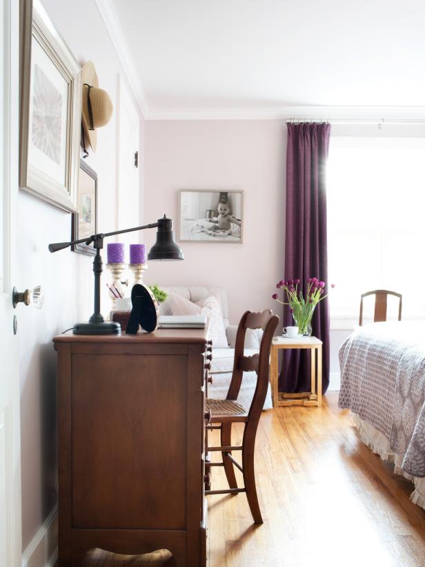 To create a calm and classic sleeping space, this modestly sized bedroom was painted a muted shade of lavender which borders on mauve. To play up the purple undertones of the wall color, the space is layered with different shades of plum. Although considered one of the hardest colors to decorate with, purple can be understated and elegant when used sparingly.