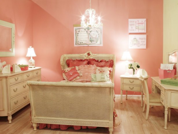 The custom bedding and wall art are color coordinated and complement the sweet, girly coral-colored walls.