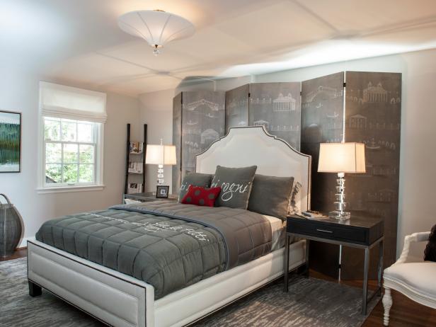 A bedroom designed for the traveling guest, Wendy Danziger of Danziger Design overcame room challenges by commissioning a custom screen by Billet Collins to hide an off-center window and enhance the room's silvery gray and white color scheme. French memo boards cover the closet doors, while tourist info on inside shelves and a doggy bed for the traveling pet complete a cozy place to call home if only for a while. Photography by Robert Radifera/DC Design House