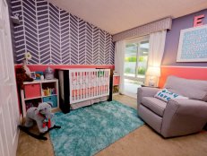 The polished, yet playful theme of the room is elegantly tied together with a stylish espresso and white crib from Nurseryworks. The wall behind the crib is the focal point with an attention-grabbing chevron pattern hand-painted by dad Eric.