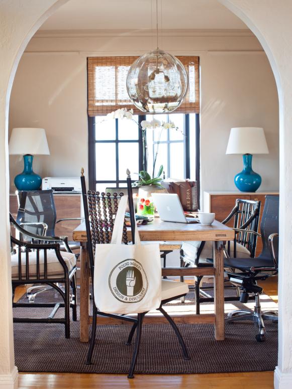 Scott and Alex turned their formal dining room into a workspace, complete with a Chinese farm table and mixed styles of seating that accomodates both dining and desk use. A pair of console chests is not only home to turquoise table lamps but they act as concealed storage to keep the coupleâ  s work-related clutter out of sight.