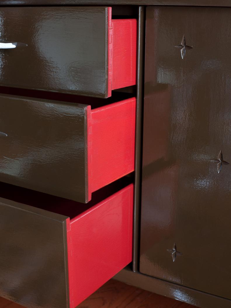 Storage console painted with dual colors, outside dark brown and the inside fire-engine red.