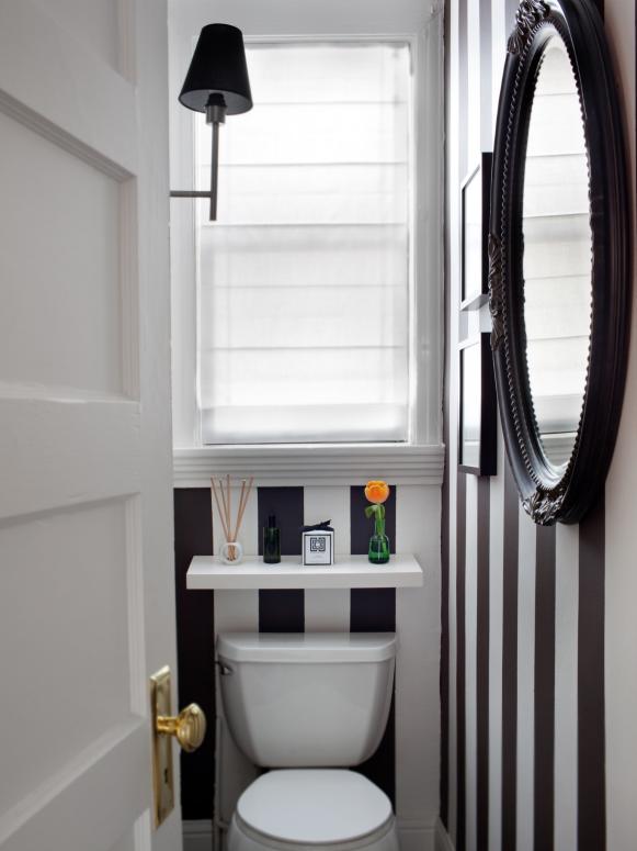To take the focus off the small bathroom, the walls were painted with 4-inch black and white stripes.