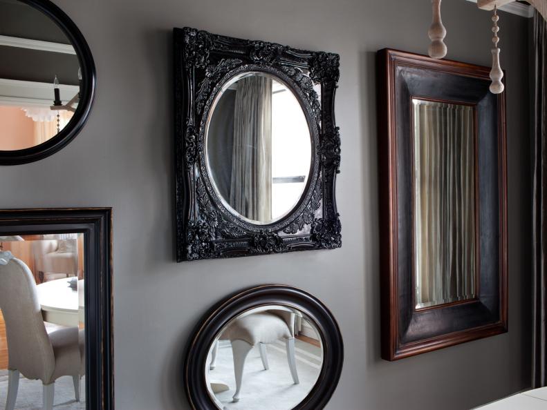 Instead of artwork, architectural style framed mirrors play with scale