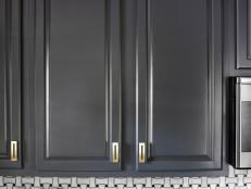 The 11-year-old, contractor-grade cabinets of this Atlanta kitchen were given a high-end update with a sprayed finish and satin brass hardware.