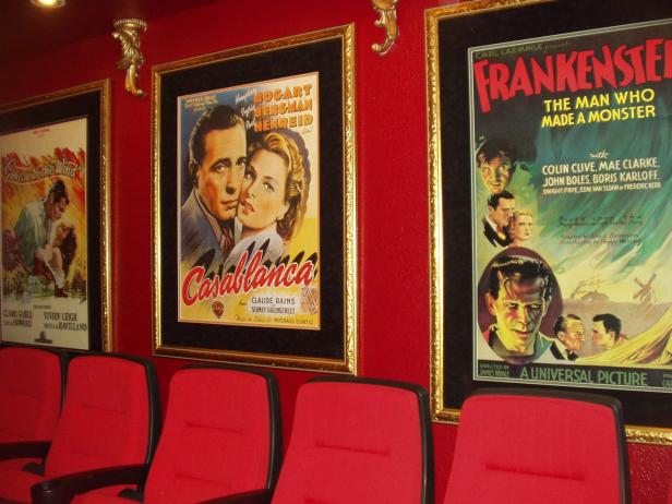 A Home theater with seating for 13 and oscar winning 1940s movie posters custom framed.  RMS user ptinney.
