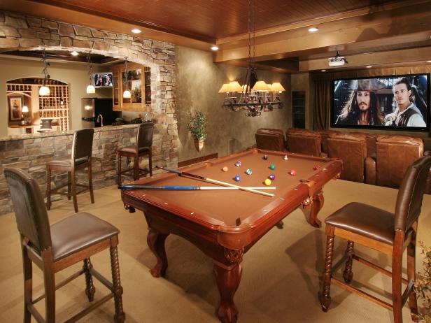 This man cave is ready to entertain with a home theater and pool table a few steps from the wine cellar and bar.