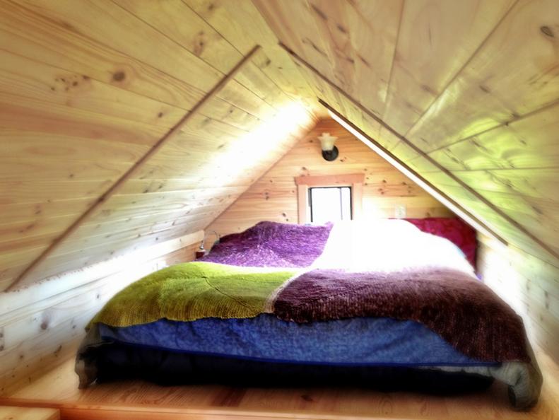 Multicolored Lofted Bed in an Attic Space