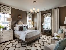 A cozy retreat defined by a color palette of chocolate brown and pale blue, the master bedroom showcases traditional style with a modern twist.
