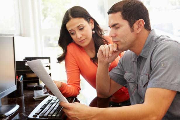 Hispanic couple working in home office