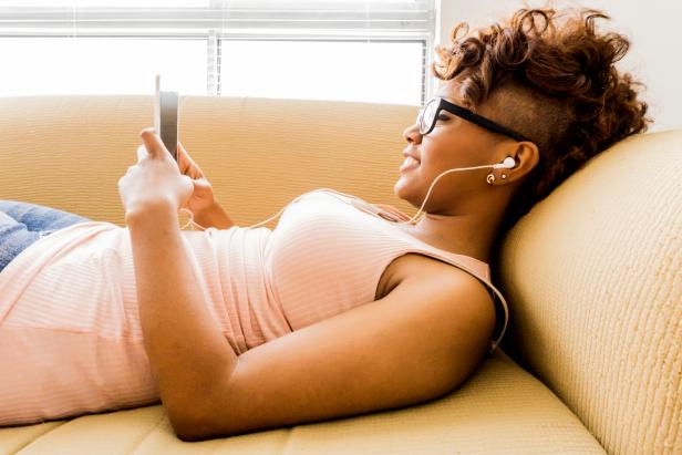 Beautiful woman using smartphone at the couch