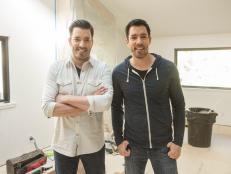 Hosts Jonathan Scott and Drew Scott pause in the living room in Drew's house, as seen on Brother vs. Brother.