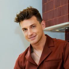 As seen on HGTV’s Starting Over with Nate and Jeremiah, Jeremiah Brent poses in the kitchen of the Trestik’s house. (Reveal)