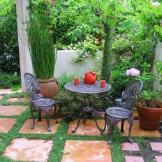 Peaceful Courtyard With Iron Table And Chairs