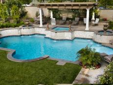 Curved Tuscan Swimming Pool With Hot Tub and Covered Poolside Patio