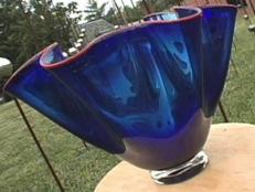 Make a decorative glass bowl from silver, blue and red blown glass using basic glassblowing techniques.