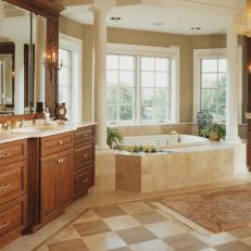 Glamorous Master Bathroom With Column Framed Bathtub, Wood Vanity and Checkerboard Neutral Floor Tile