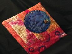 Dress up a plain book, photo album or journal with a hand-dyed and beaded fabric cover.