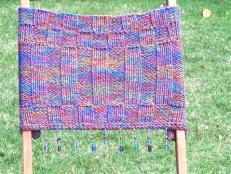 Knit a comfortable chair back perfect for folding chairs.