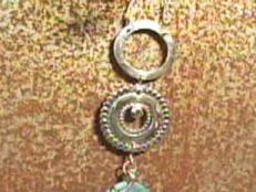 Make a three-ring metal necklace topped with a turquoise hanging pendant.