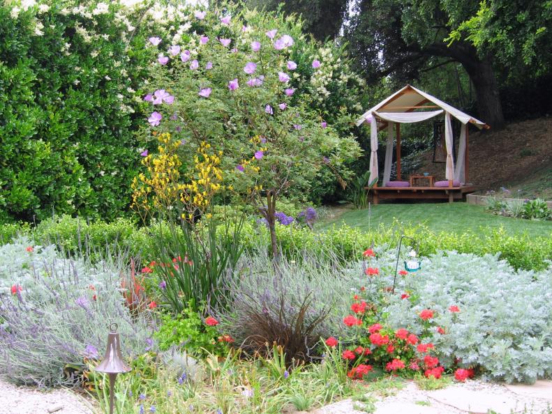Small meditation room looks out on a colorful perennial bed.