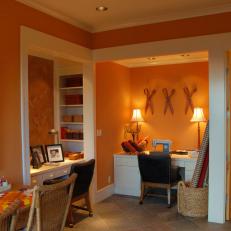 Eclectic Orange Crafts Room With Vibrant Artwork
