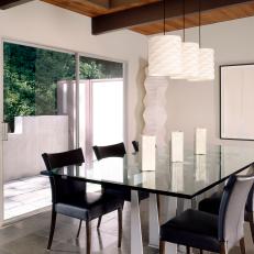 Glass Dining Table, Black Leather Chairs and Glass Sliding Door in Modern Dining Room 