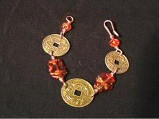 Use copper wire to create a beaded bracelet featuring three craft coins.