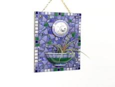 Use discarded dishes from thrift stores and garage sales to create your own mosaic wall relief.