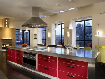 Modern Kitchen Island With Red-Front Doors and Stainless Hood