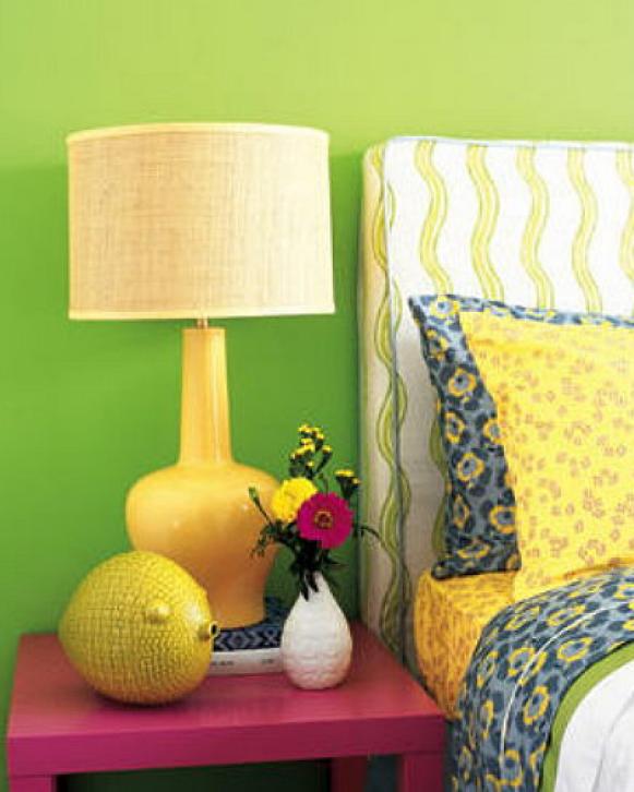 Yellow Lamp On a Pink Night Stand Against a Green Wall 