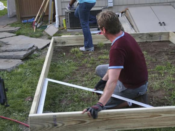 Man setting up a squaring frame. 
