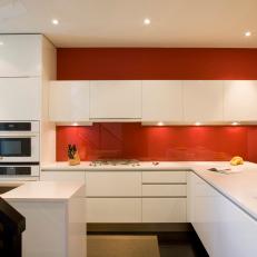 Sleek Modern Kitchen With Red Accent Wall