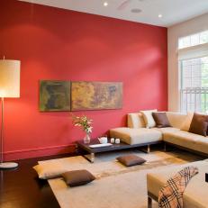 Modern Asian Living Room With Beige Sectional and Red Wall