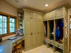 Mudroom With Green Cabinets And Cubbies 