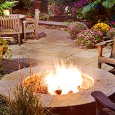stone firepit is central to backyard terrace