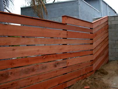 How to Build a Horizontal Plank Fence in a Hillside Backyard