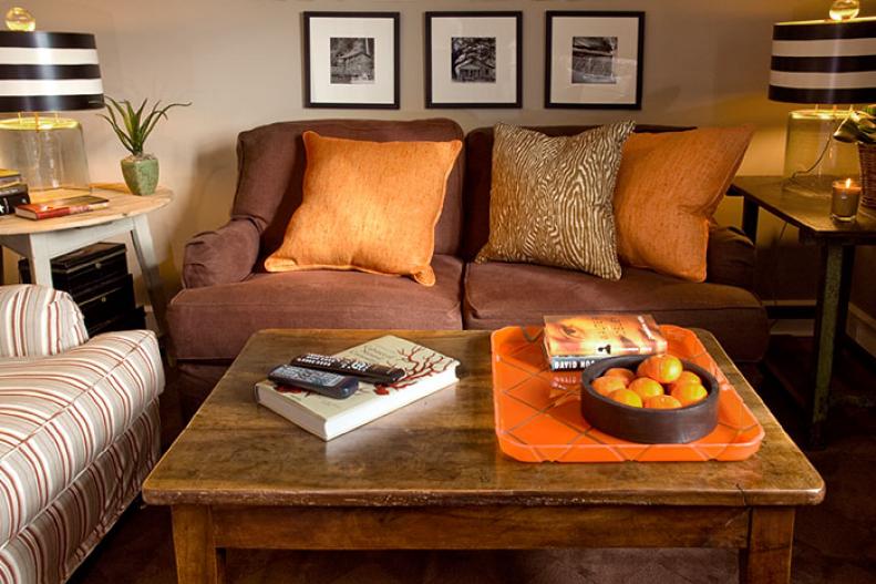 Living room with orange and wood-patterned pillows