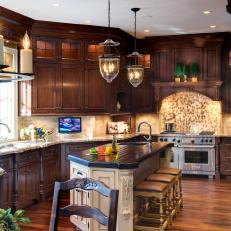 Traditional Kitchen With Rich Brown Cabinets and Beige Stools