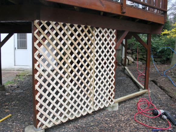 Lattice panels nailed to deck frame.