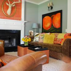 Eclectic Blue Living Room With Orange Pops of Color