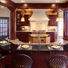 Eat-In Kitchen With Cherry Wood Cabinets and Bar