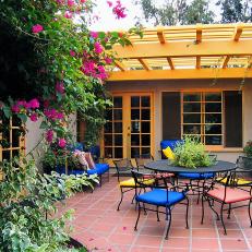 Colorful Outdoor Dining Room With Yellow Pergola