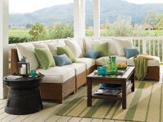 Country porch with rattan furniture and pastel accent pillows.