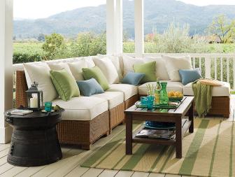Country porch with rattan furniture and pastel accent pillows.